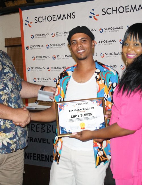 Man receives an excellence award in appreciation for a job well done.