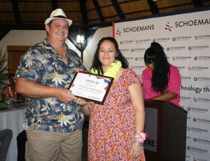Woman receives a long service award to mark a milestone of five years at Schoemans