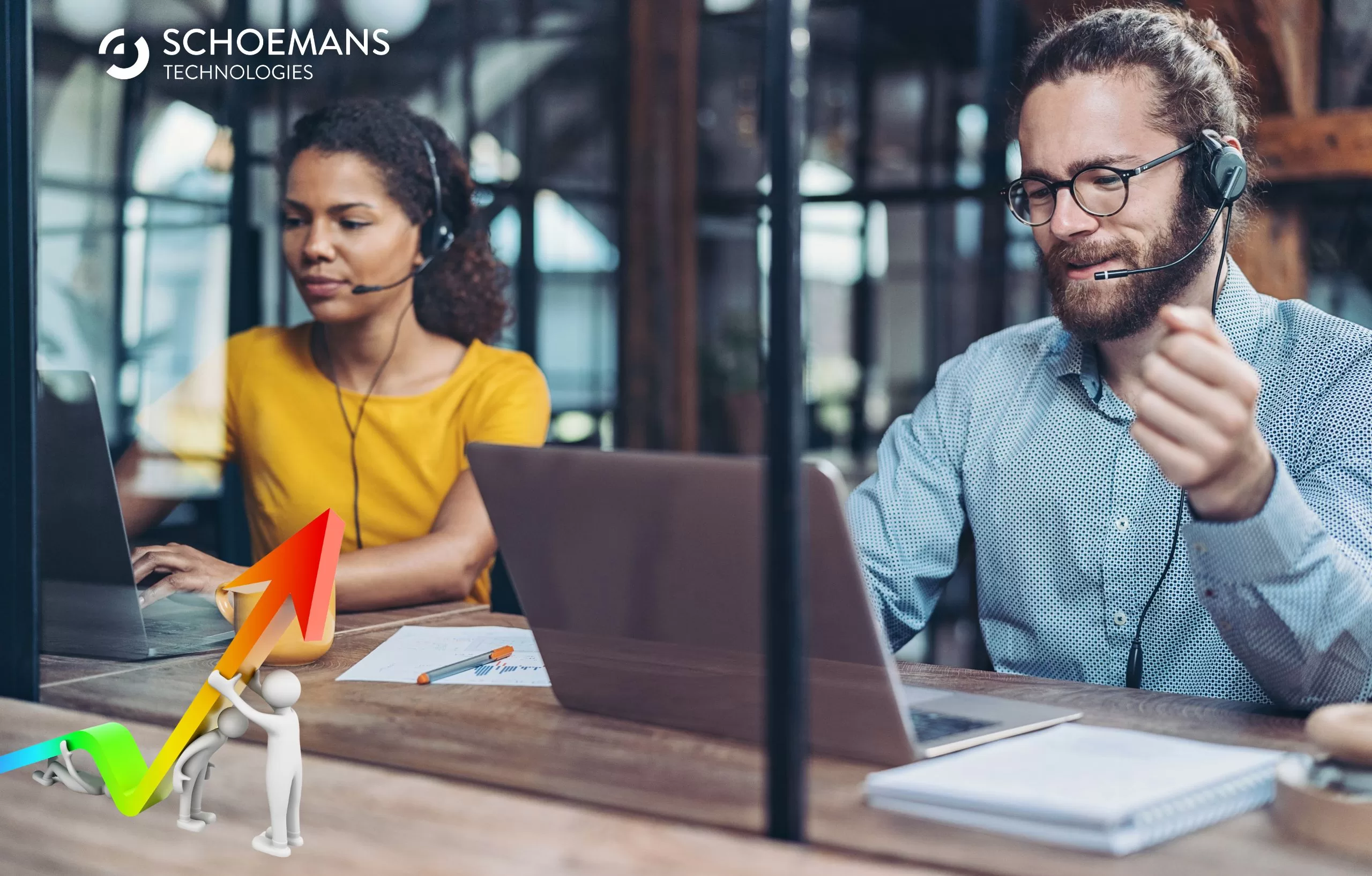 Sales people with headsets sitting at a table looking at laptop screens
